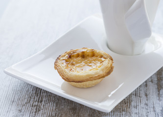 Cream cake on white plate and cup.