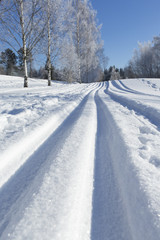 Fototapeta na wymiar Ski tracks on a sunny winter day.