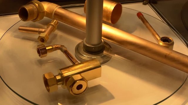 Brazed copper and brass metal pipe joint samples are revolving on display shelve