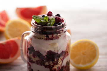yogurt with muesli and berries in small glass