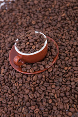 Cup of coffee on the coffee beans background