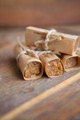 Homemade muesli bars with nuts and dried fruits on a wooden board