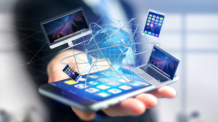 View of a Businessman holding a Computer and devices displayed on a smartphone interface with international network  - 3d render