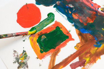 A child's hand draws gouache on white paper with a brush.