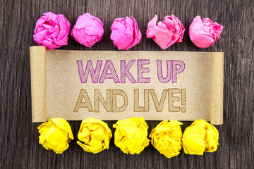 Writing text  Wake Up And Live. Concept meaning Motivational Success Dream Live Life Challenge written on sticky note paper with folded paper yellow and pink on the wooden background.