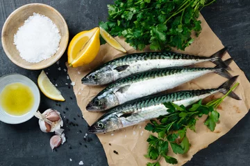 Raamstickers Fresh mackerel fish with ingredients to cook © asife