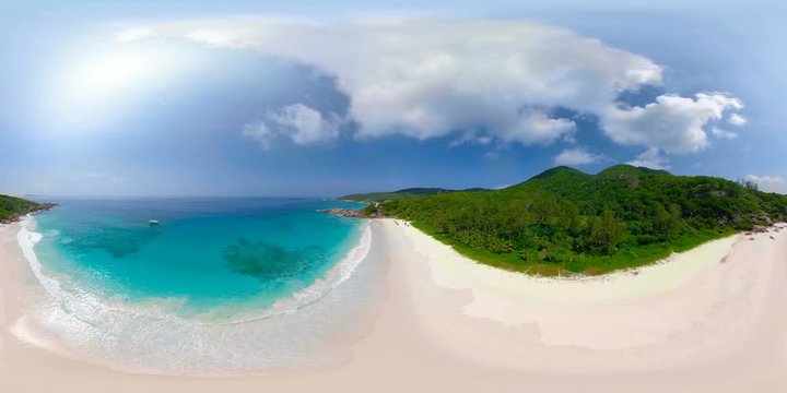 360VR 4K video aerial of tropical island sandy beach with turquoise lagoon and gentle waves on sunny vacation day from above with audio
