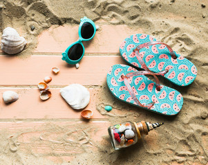 Beach accessories and seashells on wooden background .Top view