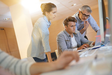Students attending web design class with teacher