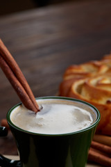 Homemade rose bread, cup of coffee, anise and cinnamon on vintage background, close-up, selective focus