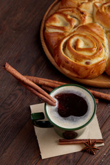 Homemade rose bread, cup of coffee, anise and cinnamon on vintage background, close-up, selective focus