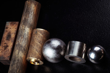 Metal details of different geometric shapes on a black background.