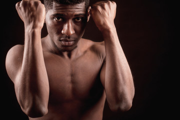close up cropped photo shirtless Afro male bending his elbows in front of him. blame himself.be in...