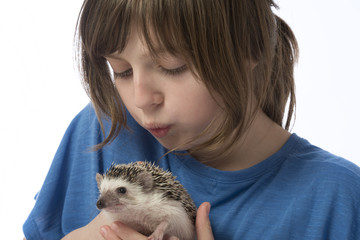 a happy litle girl with African pygmy hedgehog