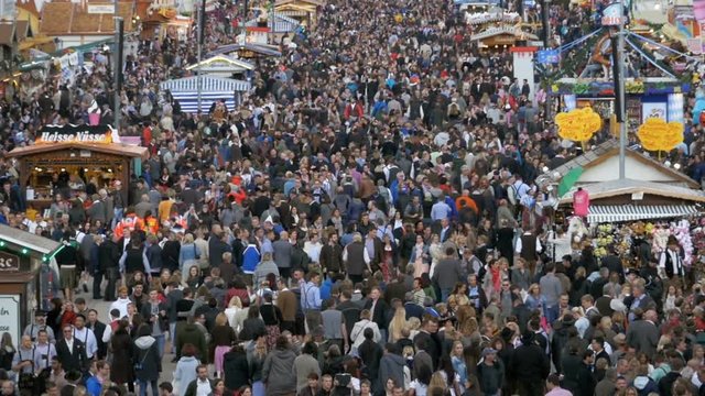 MUNICH, GERMANY, SEPTEMBER 16, 2017: Top view of crowd and attractions on central street in Oktoberfest. Bavaria. Slow Motion in 96 fps. Crowd of People in national Bavarian clothes Dirndl and