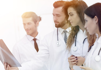 Fototapeta premium Portrait of young male doctors looking at x-ray