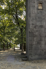 Woman, nun cleaning the square in front of Sanahin Medieval Monastery in Northern