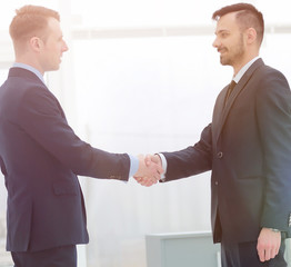 handshake financial partners in the corridor of the office