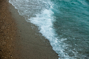 Sea background of sand. Textural background from sea small gravel, for your design