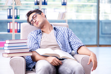 Fototapeta premium Student reading books and preparing for exams in library
