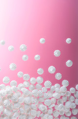 French vanilla meringue cookies on pink background with copy space.