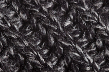 Fragment of a gray knitted woolen sweater close-up.