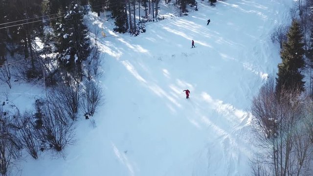  4k.Aerial. Winter time in mountains hills. Ski lift with skiers  silhouettes