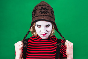 girl mime posing and grimacing in photo studio