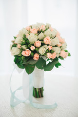 Bridal morning details. Wedding bouquet in the hands of the bride, selectoin focus