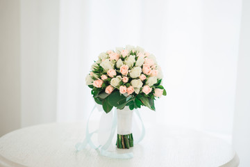 Bridal morning details. Wedding bouquet of orange, beige and pink flowers with succulent