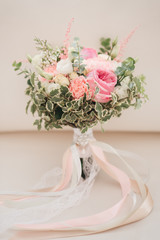 Bridal morning details. Wedding bouquet of orange, beige and pink flowers with succulent