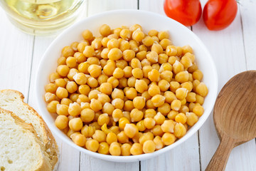 Cooked chickpeas in bowl, tomatoes and olive oil