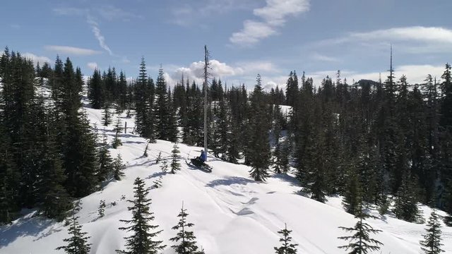 Epic Drone Filming Man Charging Snowmobile Up Mountain