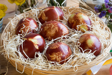 Easter eggs dyed with onion peels, with a pattern of fresh herbs