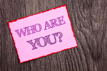 Handwriting Announcement text showing Who Are You Question. Conceptual photo Personality Identity Profile, About Me Or You written on Pink Sticky Note Paper on the wooden background.