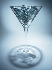 shiny metal bolts and hardware in a glass