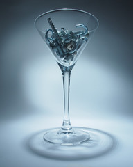 shiny metal bolts and hardware in a glass