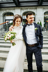 the bride and groom walking down the stairs