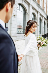 bride and groom walking around the city