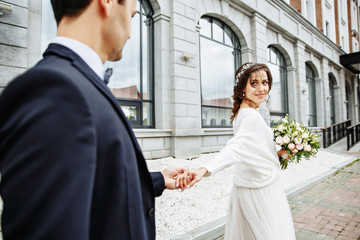 bride and groom walking around the city