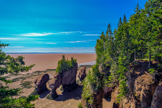 Horizontal image of The ay of Fundy and the flowerpots rocks normally under forty feet of water and the chocolate waters of the bay of Fundy
