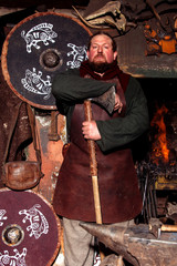 Obraz na płótnie Canvas Viking sword handles sword rack reenactment forge smith warrior weapon outfit ax shield skin fire hearth one man