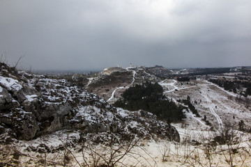 View towards the ruins of the castle in Olsztyn. Landscape with the rocks of the Krakow-Czestochowa Jura covered with a small amount of snow