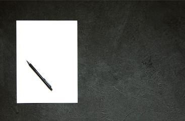 Blank notepad and pencil on concrete table.