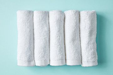Fototapeta na wymiar White spa towels on blue, from above