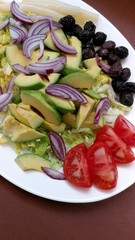 Fresh salad with avocado, asparagus and black olives