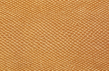 large golden background of scales similar to snakeskin with rhomboid shapes