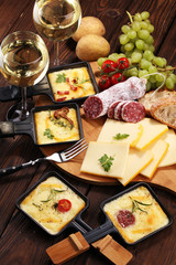 Delicious traditional Swiss melted raclette cheese on diced boiled or baked potato.