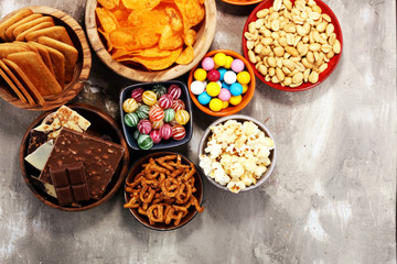 Salty snacks. Pretzels, chips, crackers in wooden bowls.