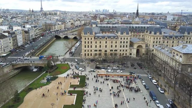 Aerial pan up from Parvis Notre-Dame - Place Jean-Paul II (Notre-Dame Cathedral square) to Eiffel tower